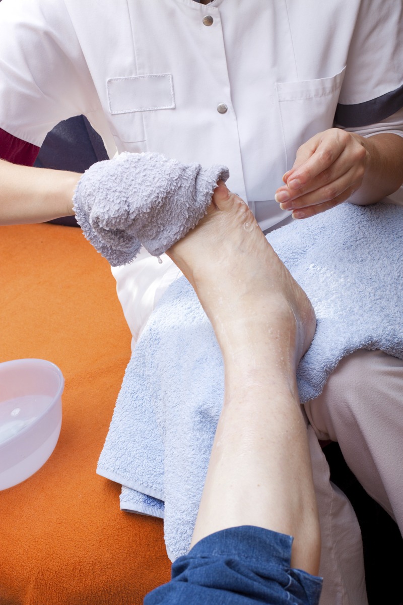 nurse doing foot care on client